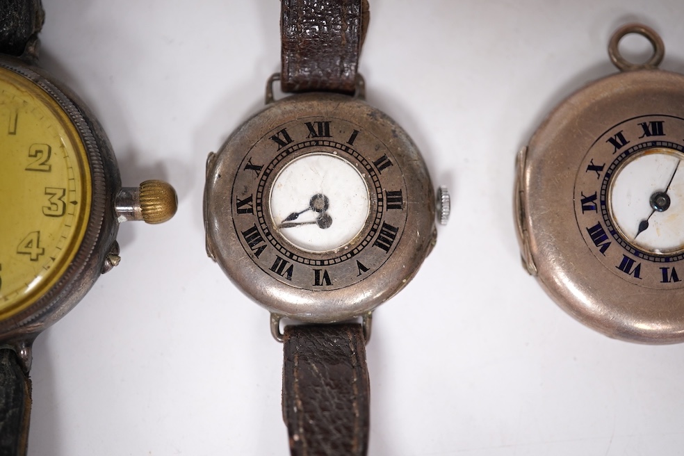 An early 20th century silver Borgel cased manual wind wrist watch(a.f.), one other similar silver half hunter manual wind wrist watch(no strap) and one other similar with a strap. Condition - poor